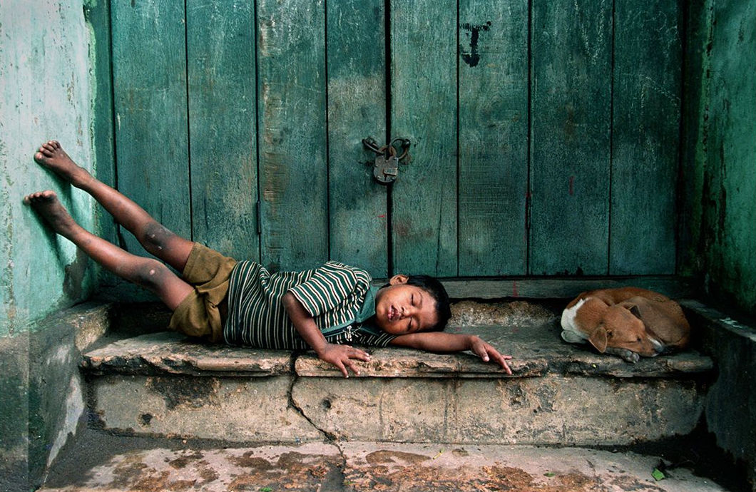 A child shares a stair for an afternoon siesta